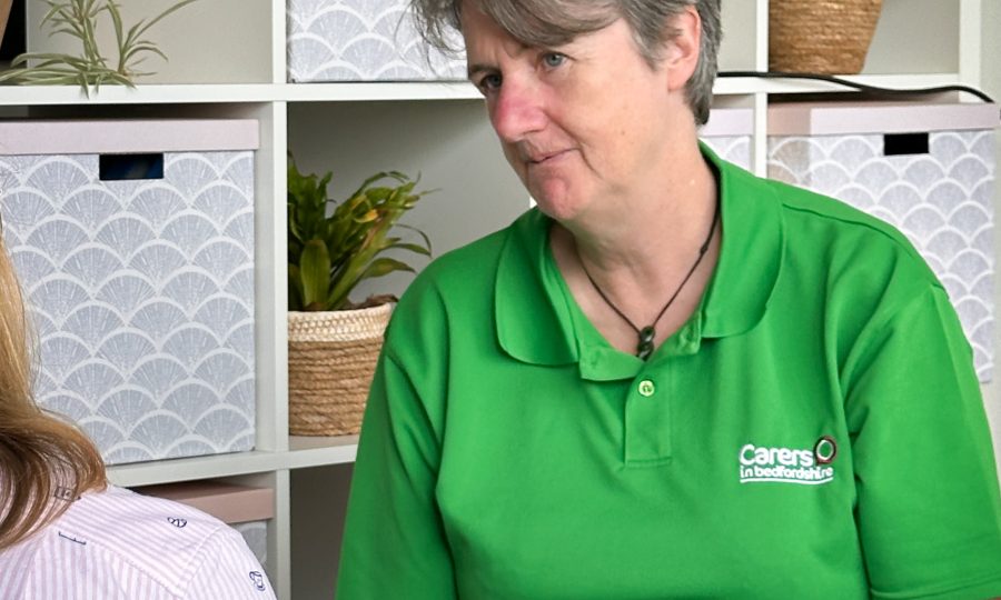 Jenny looking and listening to a Carer